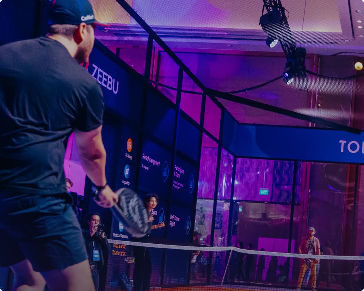 TOKEN2049 conference in Singapore with vibrant purple lighting and stage setup