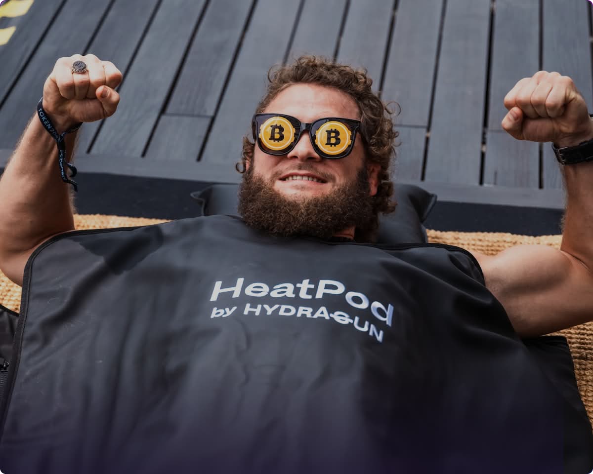 Excited participant at TOKEN2049 conference in Singapore, hanging from pull-up bar
