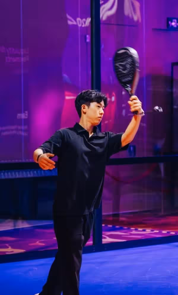 TOKEN2049 in Singapore: Squash player in black outfit on vibrant purple court