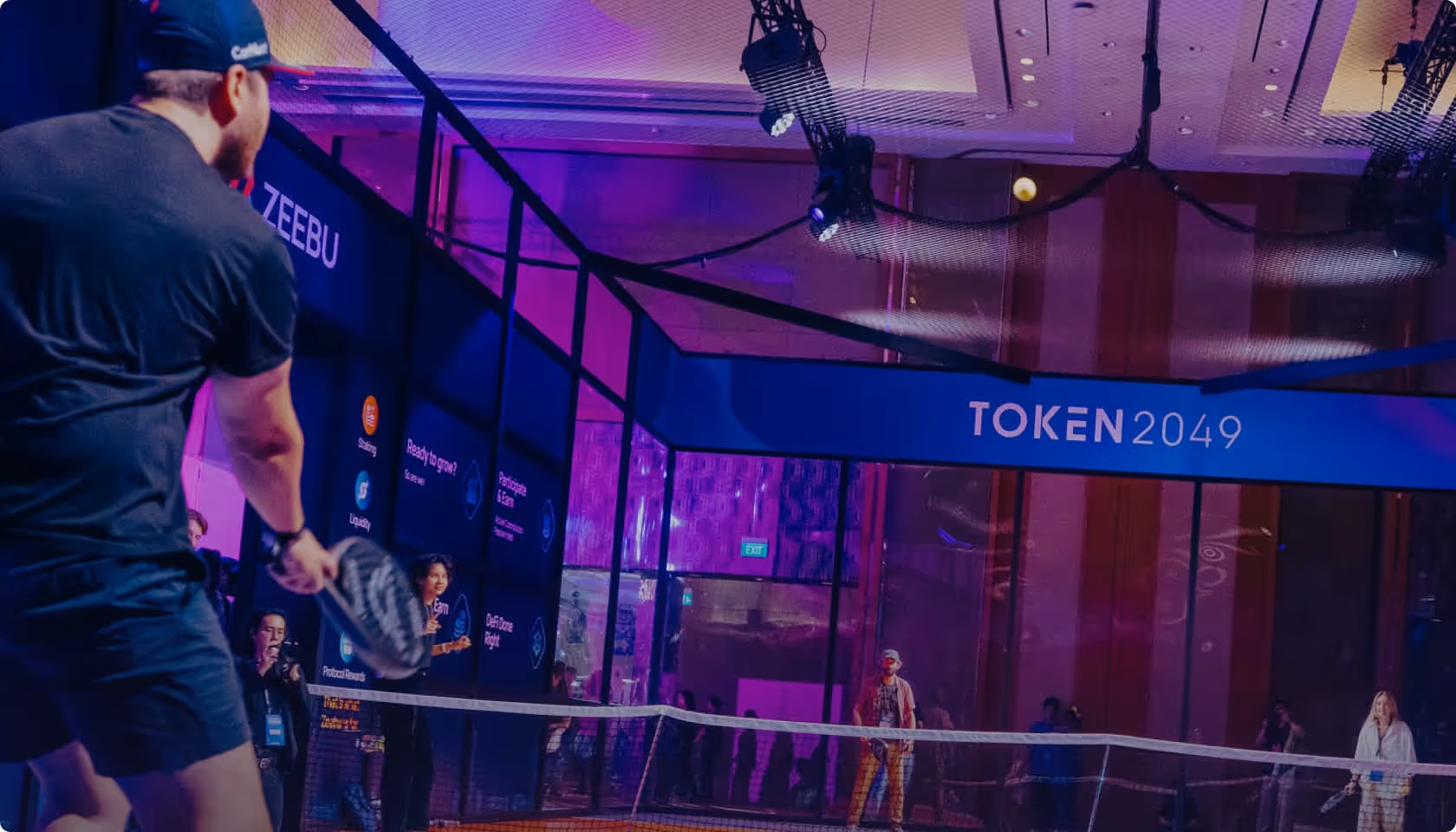 TOKEN2049 conference in Singapore with vibrant purple lighting and stage setup